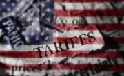 Tariffs news headlines over an American flag